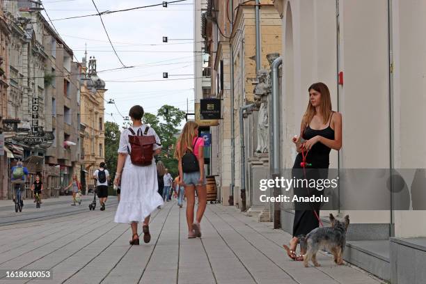 People walk on the street as daily life continues in the 4th biggest city of Croatia, Osijek on August 16, 2023.