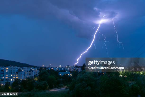 thunderstorm with lightning over city, zurich, switzerland - lightning home stock pictures, royalty-free photos & images