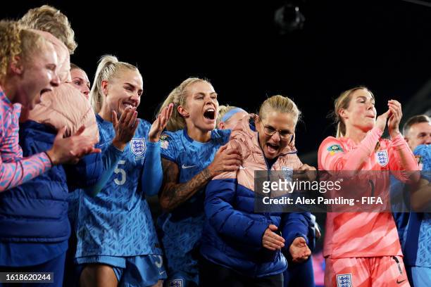 Sarina Wiegman, Head Coach of England, congratulates her players in the huddle after the team's 3-1 victory and advance to the final following the...