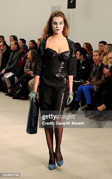 Model walks the runway at the Vivienne Westwood Red Label show during London Fashion Week Fall/Winter 2013/14 at the Saatchi Gallery on February 17,...