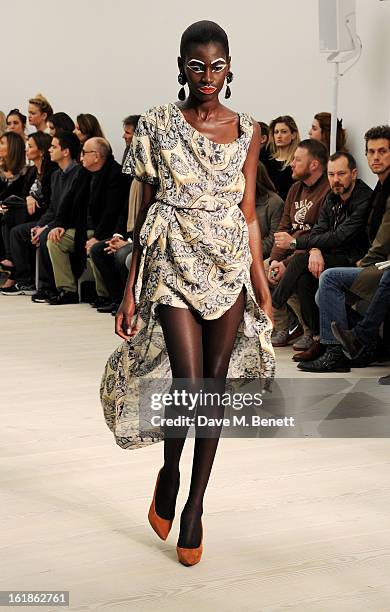 Model walks the runway at the Vivienne Westwood Red Label show during London Fashion Week Fall/Winter 2013/14 at the Saatchi Gallery on February 17,...