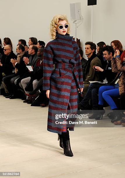 Model walks the runway at the Vivienne Westwood Red Label show during London Fashion Week Fall/Winter 2013/14 at the Saatchi Gallery on February 17,...