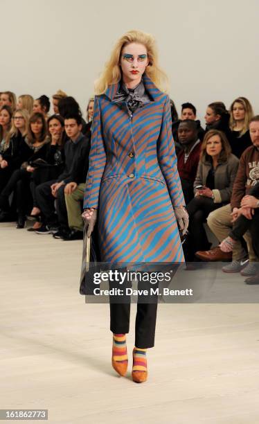 Model walks the runway at the Vivienne Westwood Red Label show during London Fashion Week Fall/Winter 2013/14 at the Saatchi Gallery on February 17,...