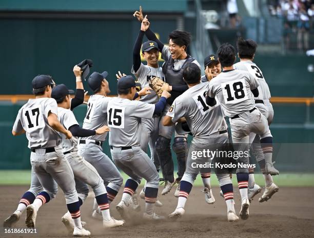 Players of Keio high school celebrate after beating Sendai Ikuei high school 8-2 in Japan's summer national high school baseball championship final...