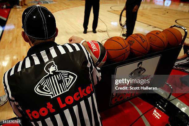 Crew member gets into position by the ball racks during the Foot Locker Three-Point Contest part of 2013 NBA All-Star Weekend at the Toyota Center on...