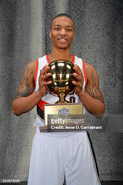 Damian Lillard of the Portland Blazers poses for a portrait with the 2013 Taco Bell Skills Challenge Trophy on State Farm All-Star Saturday Night as...