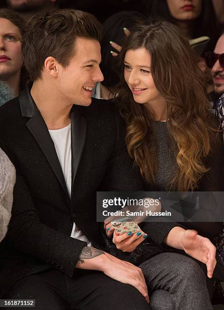 Louis Tomlinson of One Direction and Eleanor Calder attend the Topshop Unique show at the Tate Modern during London Fashion Week Fall/Winter 2013/14...