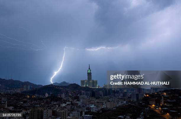 Picture taken on August 22, 2023 shows lightning over Mecca's clock tower in Saudi Arabia. Fierce storms closed schools on August 23 the desert...