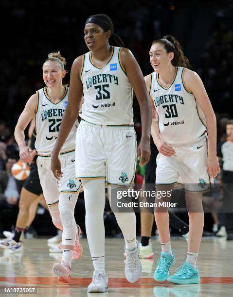 Courtney Vandersloot, Breanna Stewart and Jonquel Jones of the New York Liberty walk to the bench during a timeout after Stewart hit a 3-pointer...