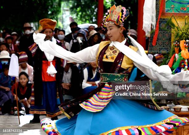 People watch Tibetan Opera performance to celebrate Shoton Festival at Norbulingka Palace on August 16, 2023 in Lhasa, Tibet Autonomous Region of...