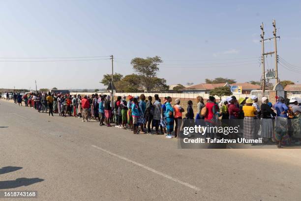 Zimbabwean citizens queue as the ballot papers took time to reach their polling station in Epworth suburb on August 23, 2023 in Harare, Zimbabwe....