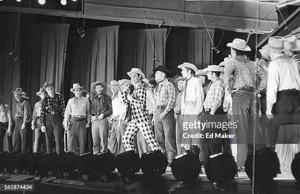 Surrounded by a male chorus as he recites his romantic woes with "Ado Annie" is comedy star Herbert Fyler of Denver, itinerant peddler who's good at...