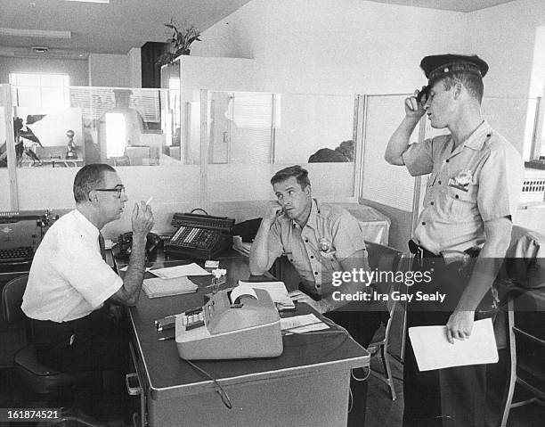 Denver Banking Firm Robbed; William Barnett, left, manager of the Lee man Industrial Bank, 25 East Fifth Ave., tells two policemen of holdup staged...