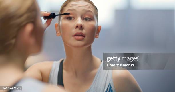 woman applying eyelash makeup - applying mascara stock pictures, royalty-free photos & images