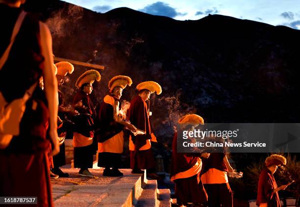 Tibetan monks attend a traditional "sunning the Buddha" ceremony at the Drepung Monastery on August 16, 2023 in Lhasa, Tibet Autonomous Region of...
