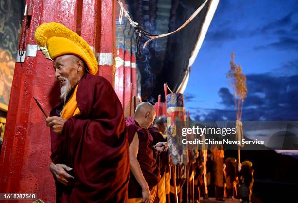 Tibetan monks attend a traditional "sunning the Buddha" ceremony at the Drepung Monastery on August 16, 2023 in Lhasa, Tibet Autonomous Region of...