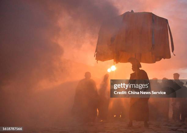 Tibetan monks attend a traditional "sunning the Buddha" ceremony at the Drepung Monastery on August 16, 2023 in Lhasa, Tibet Autonomous Region of...