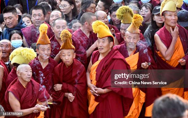 Tibetan monks attend a traditional "sunning the Buddha" ceremony at the Drepung Monastery on August 16, 2023 in Lhasa, Tibet Autonomous Region of...