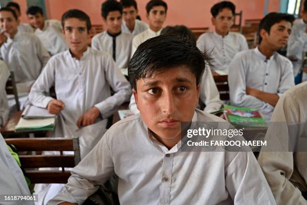 Rizwan Ullah , a survivor of the cable car accident sits in a classroom at a school in the Pashto village of mountainous Khyber Pakhtunkhwa province...