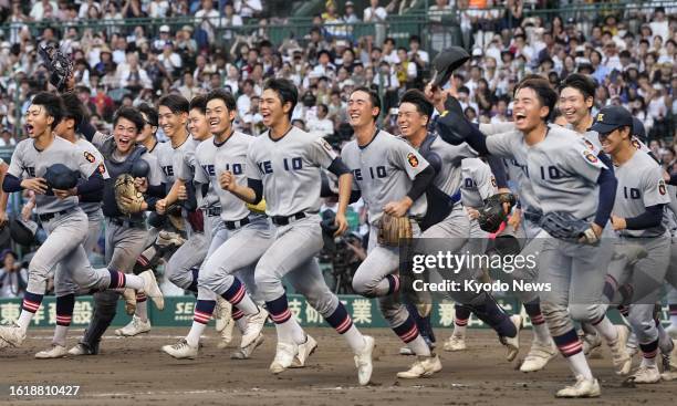 Players of Keio high school run toward their supporters in the stands after beating Sendai Ikuei high school 8-2 in Japan's summer national high...