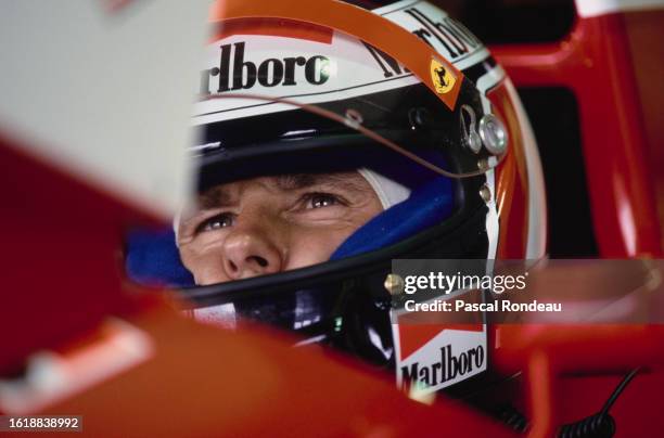 Gerhard Berger from Austria checks the lap times on the Tag Heuer monitor from the cockpit of the Scuderia Ferrari Ferrari 412T1 Ferrari V12 inside...