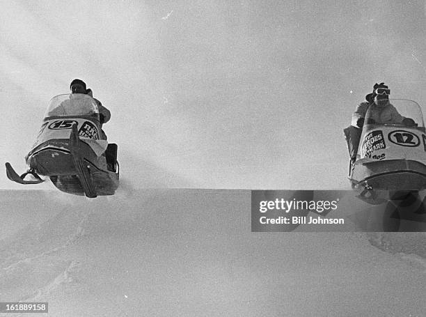 Two Ski-Doos race over a crest at 35 m.p.h. In the snow mobile at the left is Bill Nation of Hotchkiss, Colo., and, at the right, Dave Watson of...