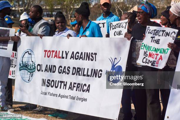 Demonstrators hold a banner reading 'Totally Against Oil And Gas Drilling In South Africa' during a protest against the East African Crude Oil...