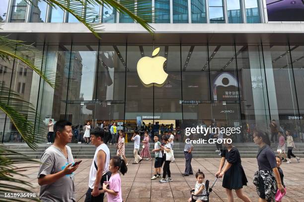 Customers walk past an Apple store in Shanghai, China, August 23, 2023.