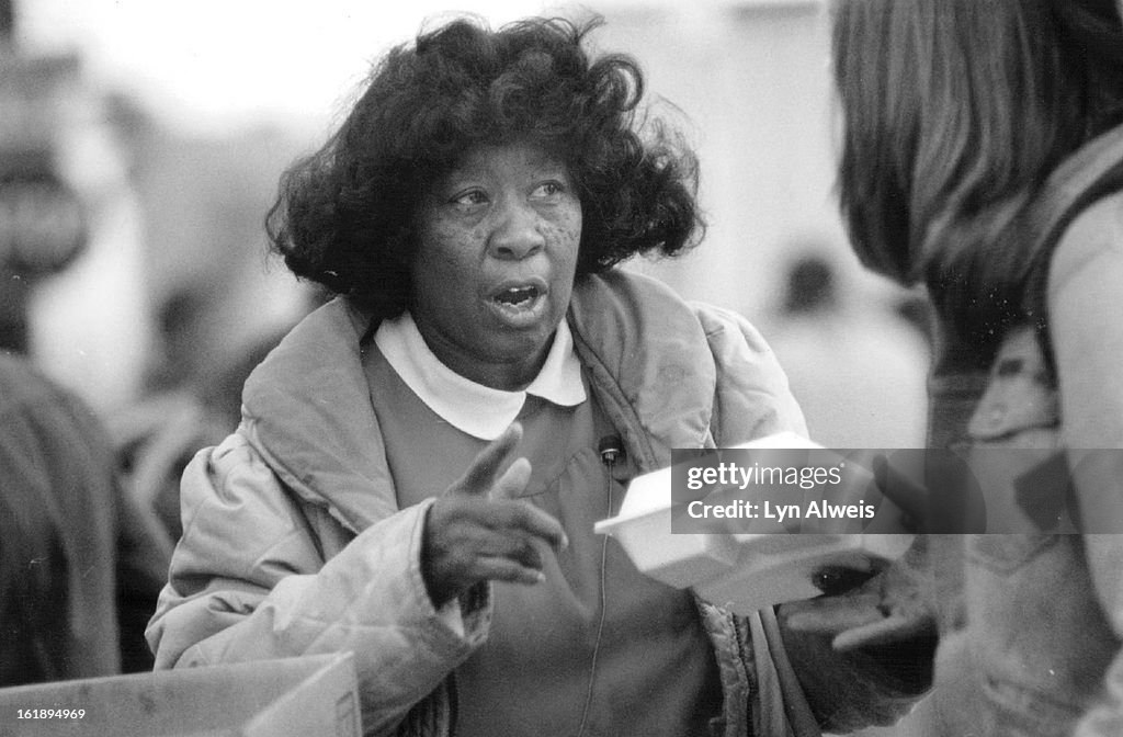 DEC 18 1987; Hattie Anthony hands out holiday dinners at 22nd and Larimer they had enough to serve 3