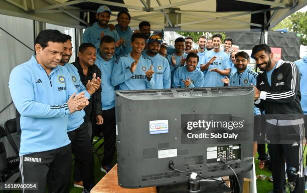 Dublin , Ireland - 23 August 2023; India players and staff applaud as they watch a television, broadcasting Indian Space Research Organisation's...