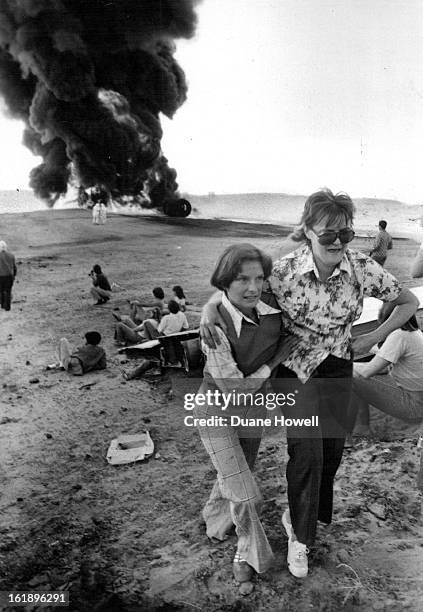 Emergency Preparedness Tested; A "surviving flight attendant,"T-=above, helps an "injured passenger" from one of two crashed airplanes during a...