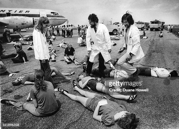 Drill Tests Response to Aircraft accident; A victim of a simulated aircraft accident is removed, left, from the "crashed" airplane in an exercise...