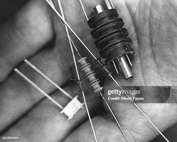 These resistors, used in construction of missiles and computers are as small as one gram in weight. They are among the electronic devices made by...