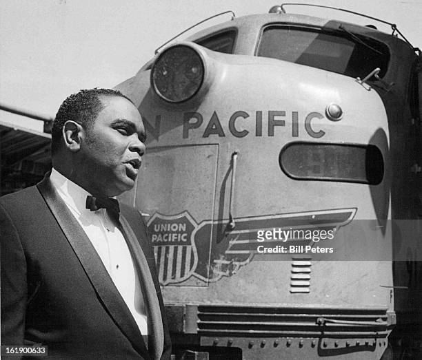 Amtrak's Arrival makes future uncertain for railroader W. D. Booker Sr.; Union Pacific employe, who lives in Denver, stands before "City of Denver.";