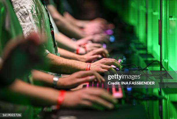 Visitors play the Stalker 2 game at the Xbox booth at the Gamescom video game fair in Cologne, western Germany, on August 23, 2023. According to the...