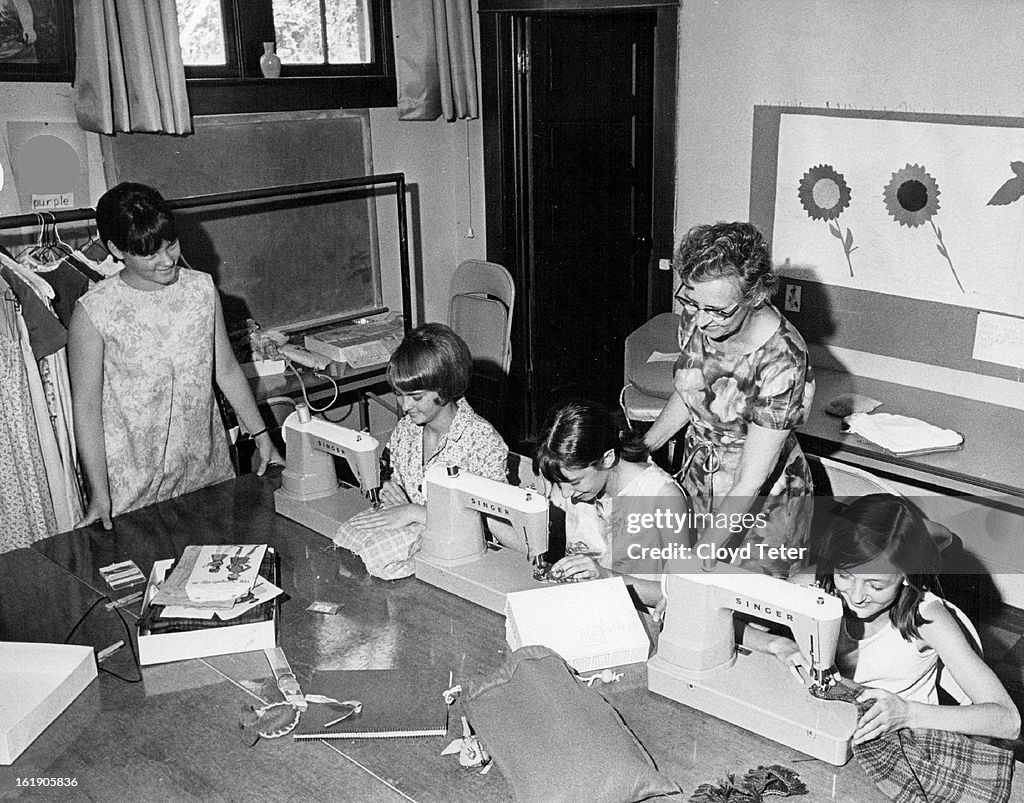 AUG 25 1967, AUG 30 1967; Mrs. Aurelia Hill, Right, Instructs Girls In Intricacies Of Sewing; Four o