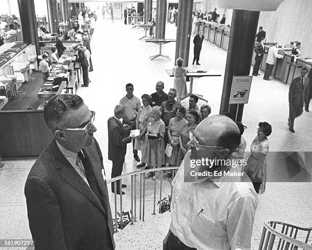 Teachers Learn About Banking; Roger Knight, left foreground, president of the Denver U.S. National Bank, answers questions of Lee R. West, professor...