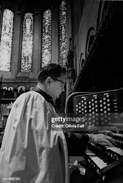 Dr. Robert Finster At St. John's Pipe Organ; With the beautiful aspe windows in the background, Dr. Finster sits at the pipe organ in sancutary for...