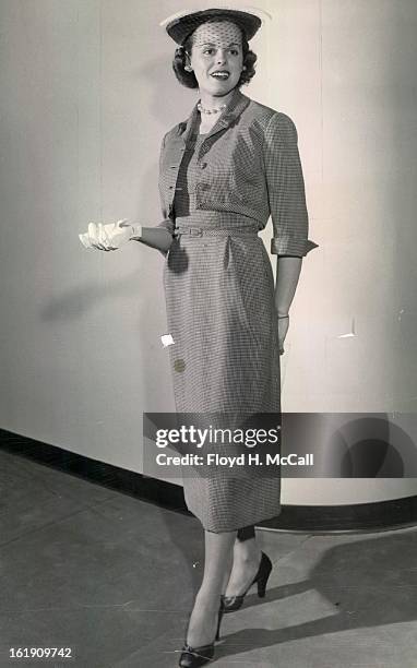 Campbell, Donald C. Mrs; Fashion show model; Hattie Carnegie's pin - check wool costume features self-material detail and tabs on the brief jacket...