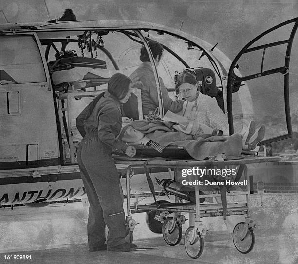 Plam Brown, left is assisted by nurse from the emergency room in getting an auto - accident victim onto a stretcher. Some patients are treated at...