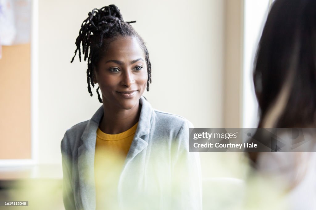 Mental health counselor meets with teenage patient to discuss high school