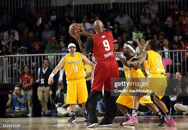 Legend Ron Harper looks to pass the ball during the NBA Cares Special Olympics Unity Sports Basketball Game on Center Court during the 2013 NBA Jam...