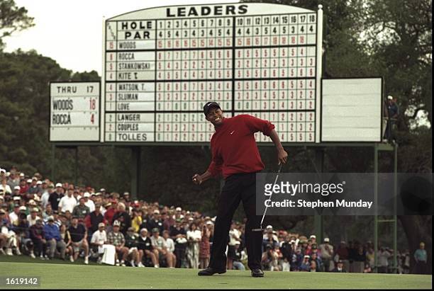Tiger Woods of the USA celebrates after sinking a 4 feet putt to win the US Masters at Augusta, Georgia. Woods won the tournament with a record low...