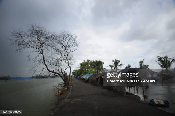 Bangladeshi residents take shelter on an embankment in Koyra on August 8, 2010. Cyclone Aila slammed into southern Bangladesh on May 26 and while the...
