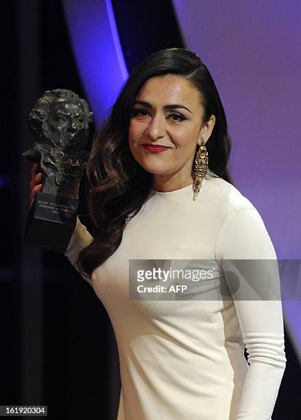 Spanish actress Candela Pena holds her trophy after winning the Goya award for best supporting actress for her role in the film "Una pistola en cada...