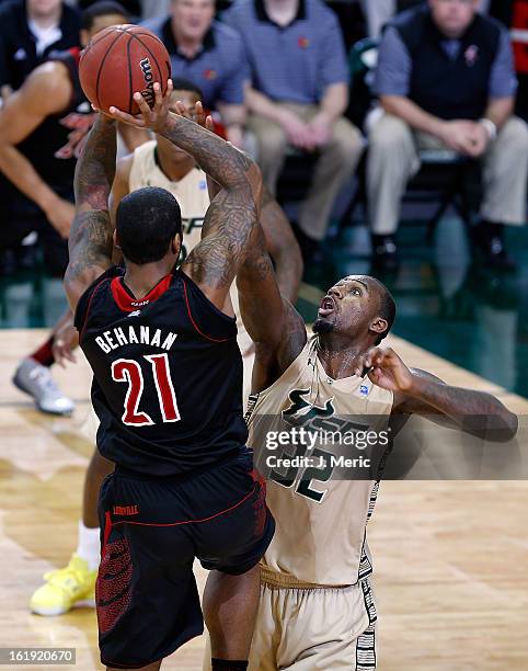 Chane Behanan of the Louisville Cardinals passes over Toarlyn Fitzpatrick of the South Florida Bulls during the game at the Sun Dome on February 17,...