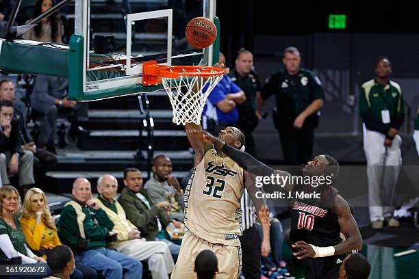 Toarlyn Fitzpatrick of the South Florida Bulls lays the ball up as Gorgui Dieng of the Louisville Cardinals defends during the game at the Sun Dome...