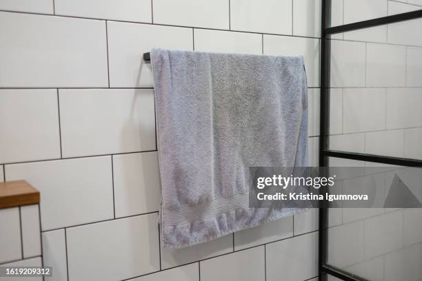 towel hanging in the bathroom by the shower. faded old towel - toalha imagens e fotografias de stock