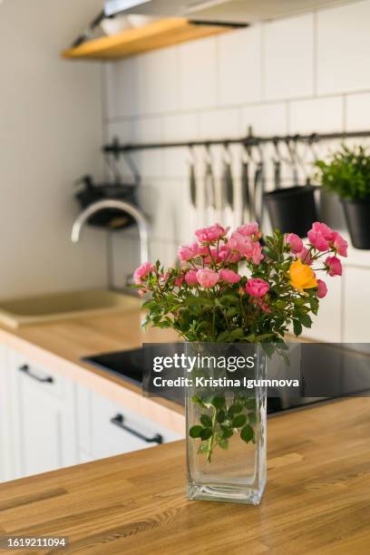 scandinavian kitchen interior with roses bouquet in vase - kristina rose stock pictures, royalty-free photos & images