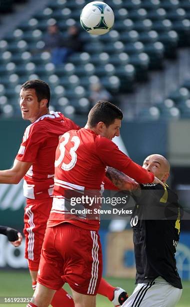 Blas Perez of FC Dallas and Kenny Cooper of FC Dallas battle for a ball with Daniel Majstorovic of AIK during the first half of the game at Jeld-Wen...